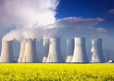 16218021 - nuclear power plant with yellow field and big blue clouds